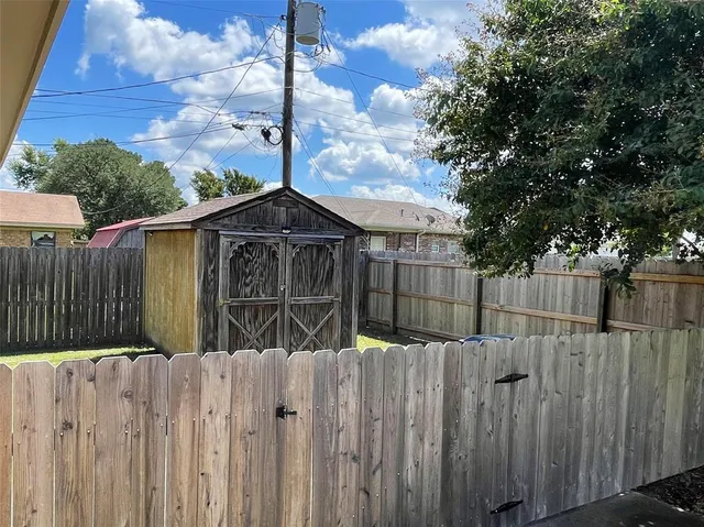 a wooden fence with a trees in the background