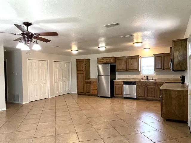 a view of a kitchen with a sink and cabinets