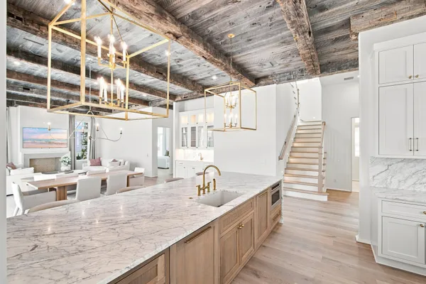 a kitchen with stainless steel appliances granite countertop a sink and a wooden floors