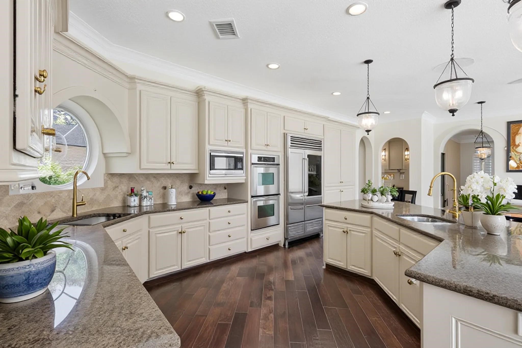 3315 Riviera Drive Sugar Land, TX 77479 - Photo 20 of 42 a large kitchen with granite countertop a white cabinets stove and sink