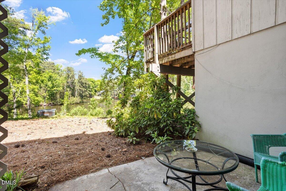 5045 Tall Pines Court Raleigh, NC 27609 - Photo 32 of 37 a view of a chairs and table in a backyard