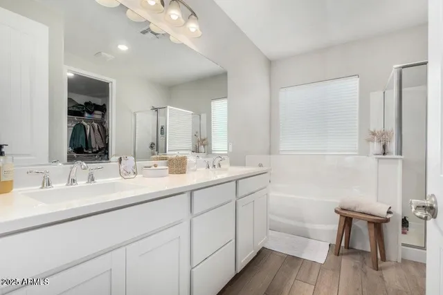 a bathroom with a double vanity sink and a mirror