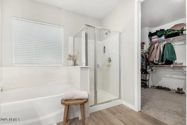 a bathroom with a tub a sink and a shower