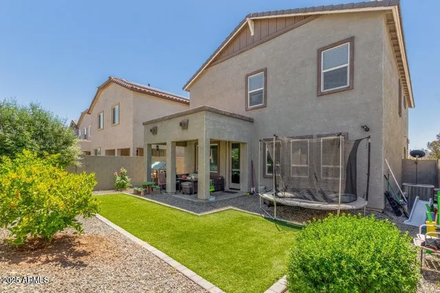 a front view of a house with a yard table and chairs