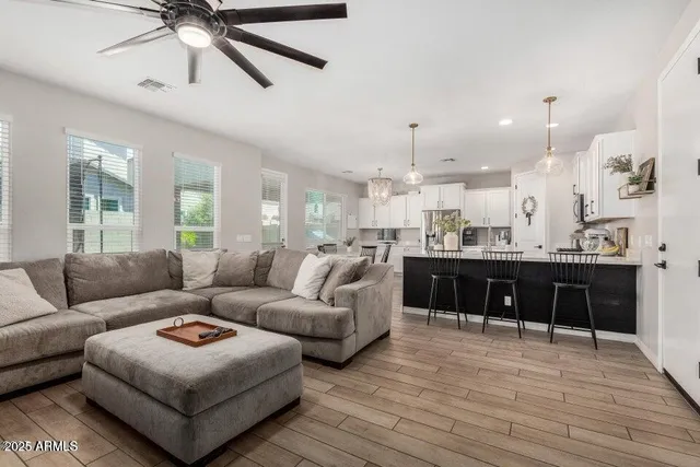 a living room with furniture and a wooden floor