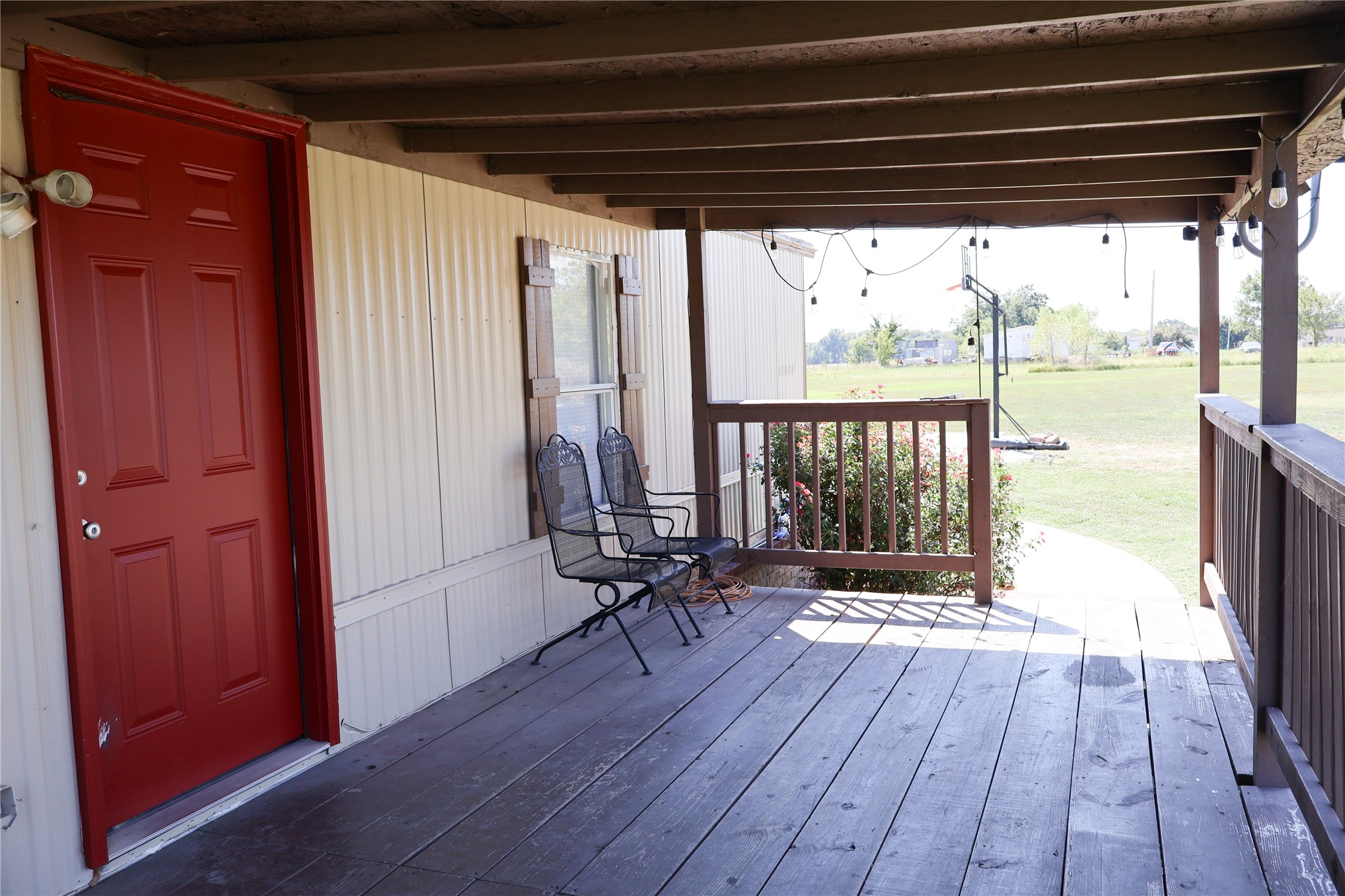 16398 Hawk Road Beggs, OK 74421 - Photo 6 of 15 Covered wood deck with wood plank flooring