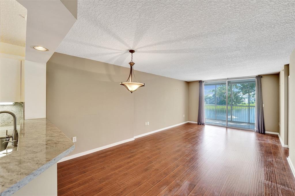 9563 Weldon Circle, Unit D212 Tamarac, FL 33321 - Photo 18 of 69 a view of a livingroom with wooden floor and a large window