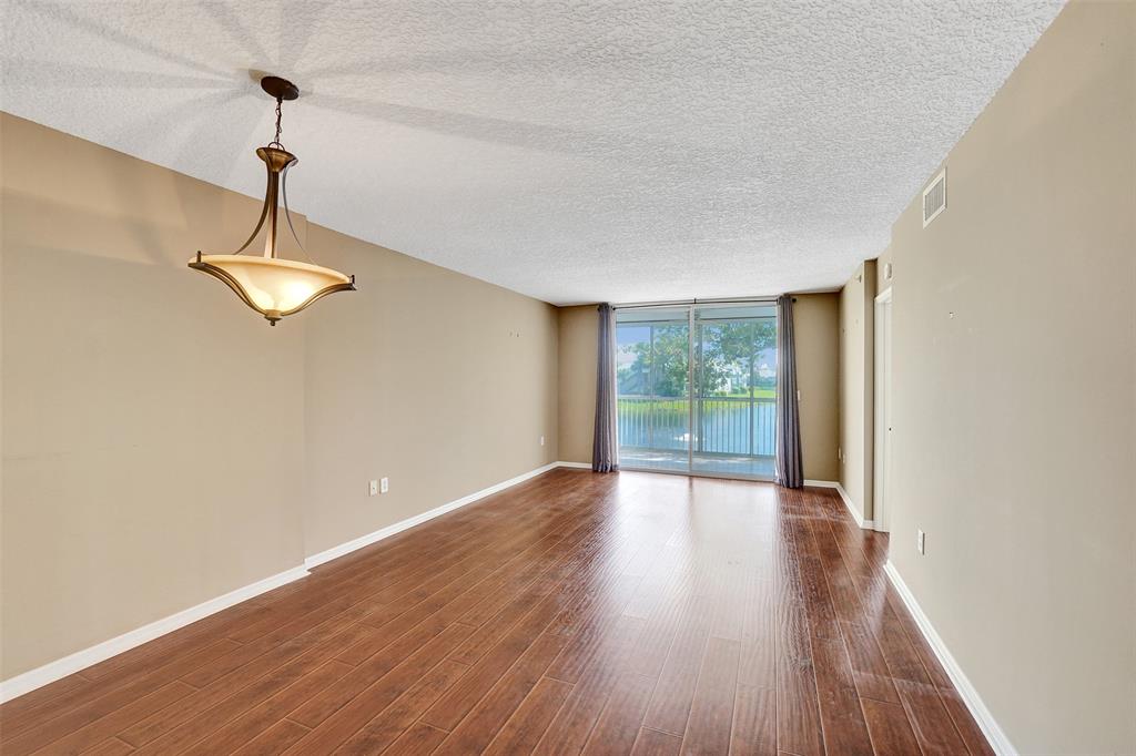 9563 Weldon Circle, Unit D212 Tamarac, FL 33321 - Photo 19 of 69 a view of empty room with wooden floor and fan