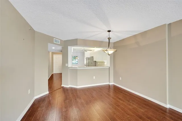 a view of a room with wooden floor fan and a window