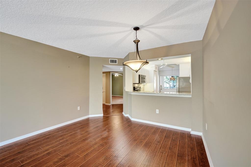 9563 Weldon Circle, Unit D212 Tamarac, FL 33321 - Photo 22 of 69 a view of a room with a wooden floor and a ceiling fan
