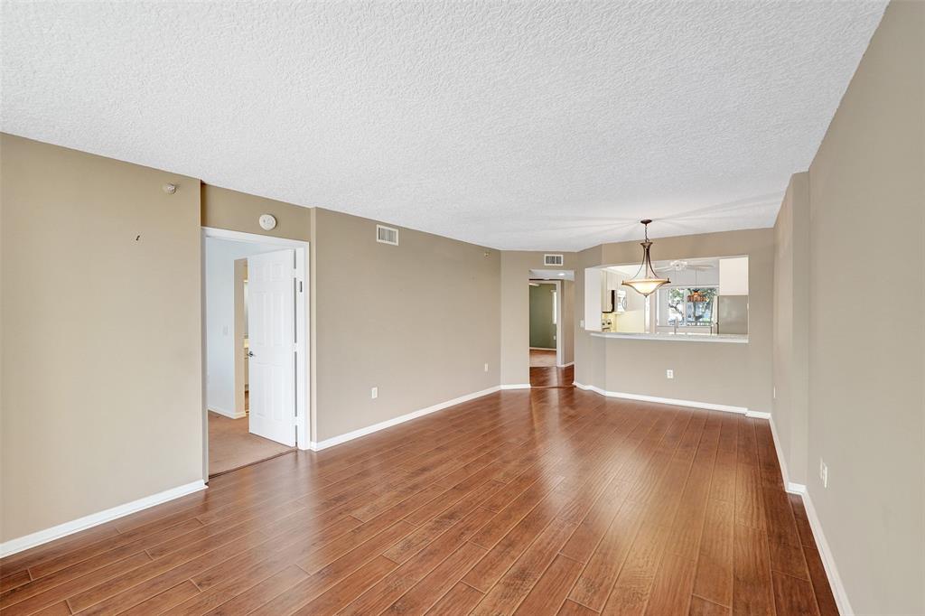 9563 Weldon Circle, Unit D212 Tamarac, FL 33321 - Photo 25 of 69 a view of an empty room with wooden floor
