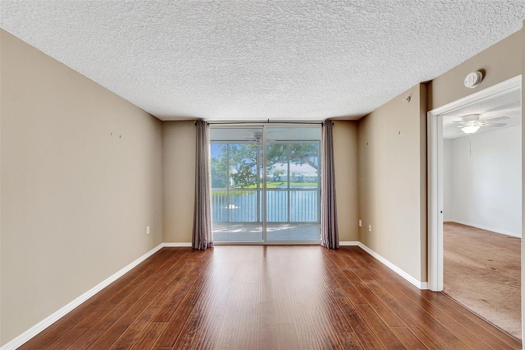 9563 Weldon Circle, Unit D212 Tamarac, FL 33321 - Photo 29 of 69 wooden floor in an empty room with a window