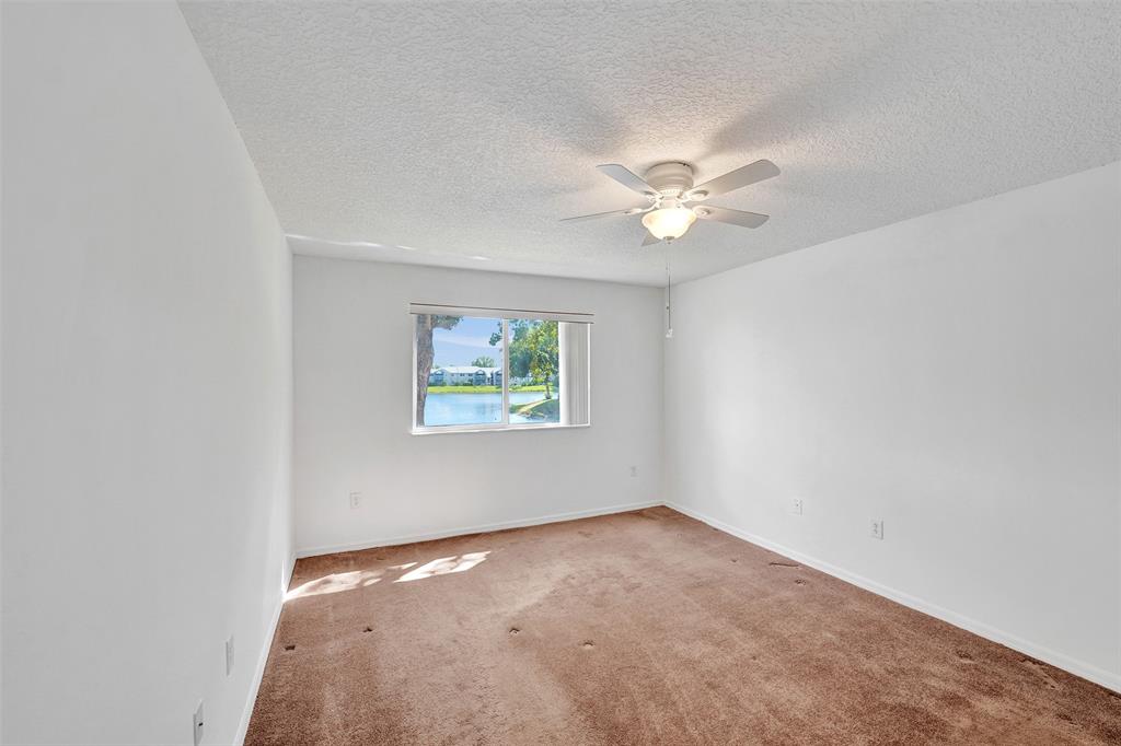 9563 Weldon Circle, Unit D212 Tamarac, FL 33321 - Photo 30 of 69 an empty room with windows and fan