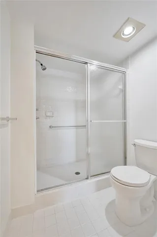 a view of hallway with bathroom and wooden floor