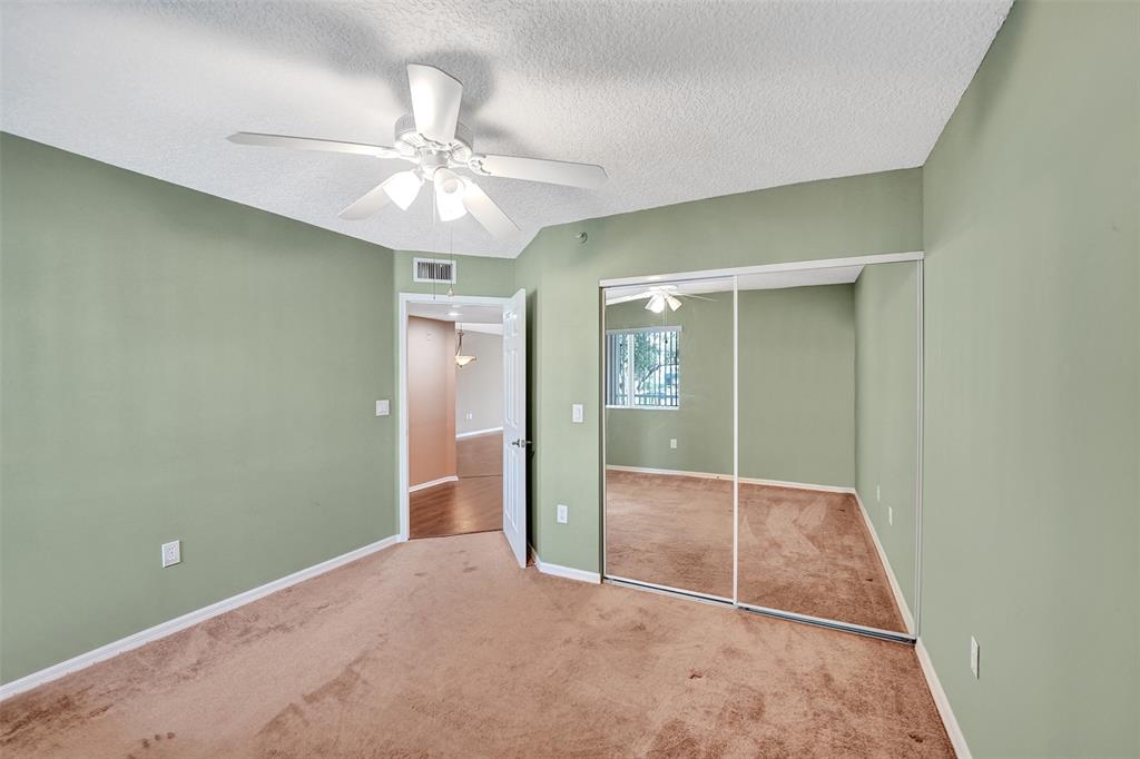 9563 Weldon Circle, Unit D212 Tamarac, FL 33321 - Photo 40 of 69 an empty room with closet and a chandelier fan