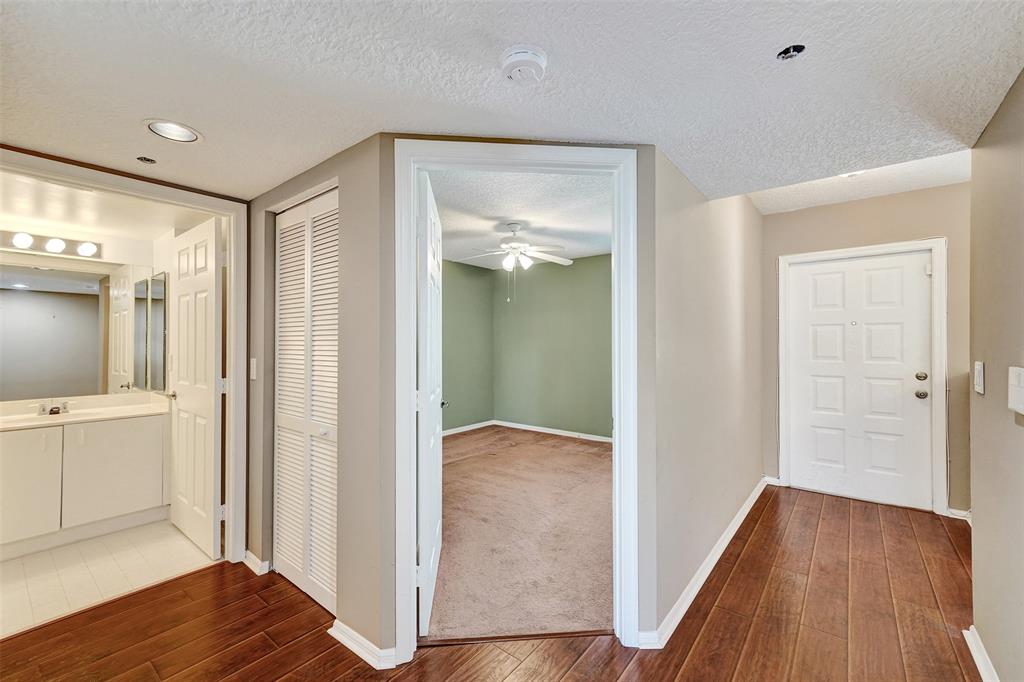 9563 Weldon Circle, Unit D212 Tamarac, FL 33321 - Photo 43 of 69 a view of hallway with bathroom and wooden floor