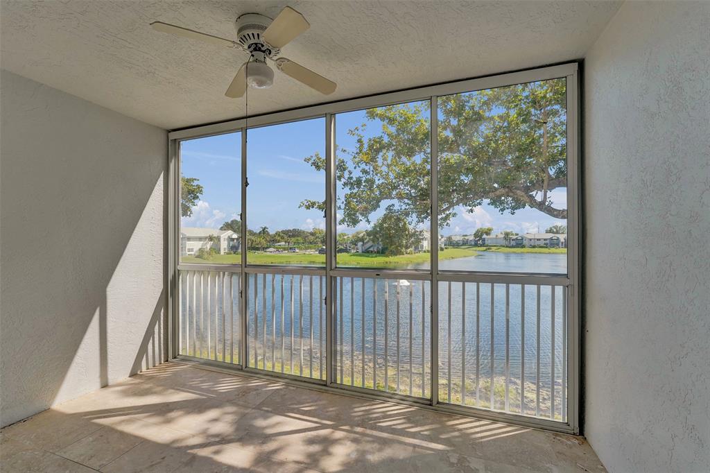 9563 Weldon Circle, Unit D212 Tamarac, FL 33321 - Photo 48 of 69 a view of a porch with a floor to ceiling window