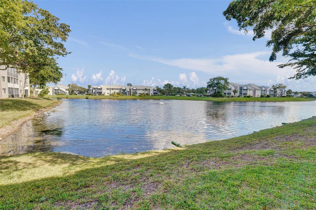 9563 Weldon Circle, Unit D212 Tamarac, FL 33321 - Photo 54 of 69 a view of a lake with a lake
