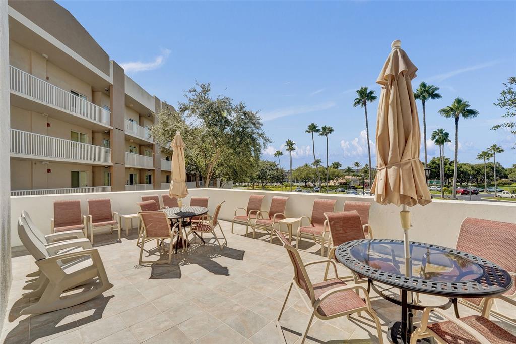 9563 Weldon Circle, Unit D212 Tamarac, FL 33321 - Photo 60 of 69 a view of a patio with couches table and chairs and potted plants