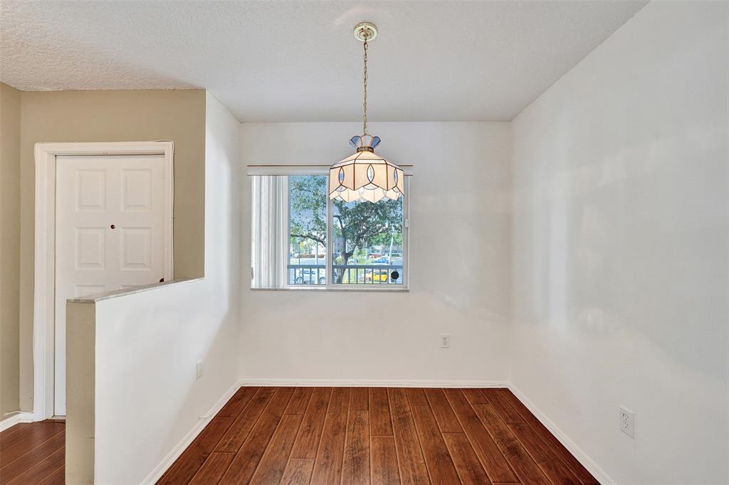 9563 Weldon Circle, Unit D212 Tamarac, FL 33321 - Photo 6 of 69 a view of a room with wooden floor a ceiling fan and window
