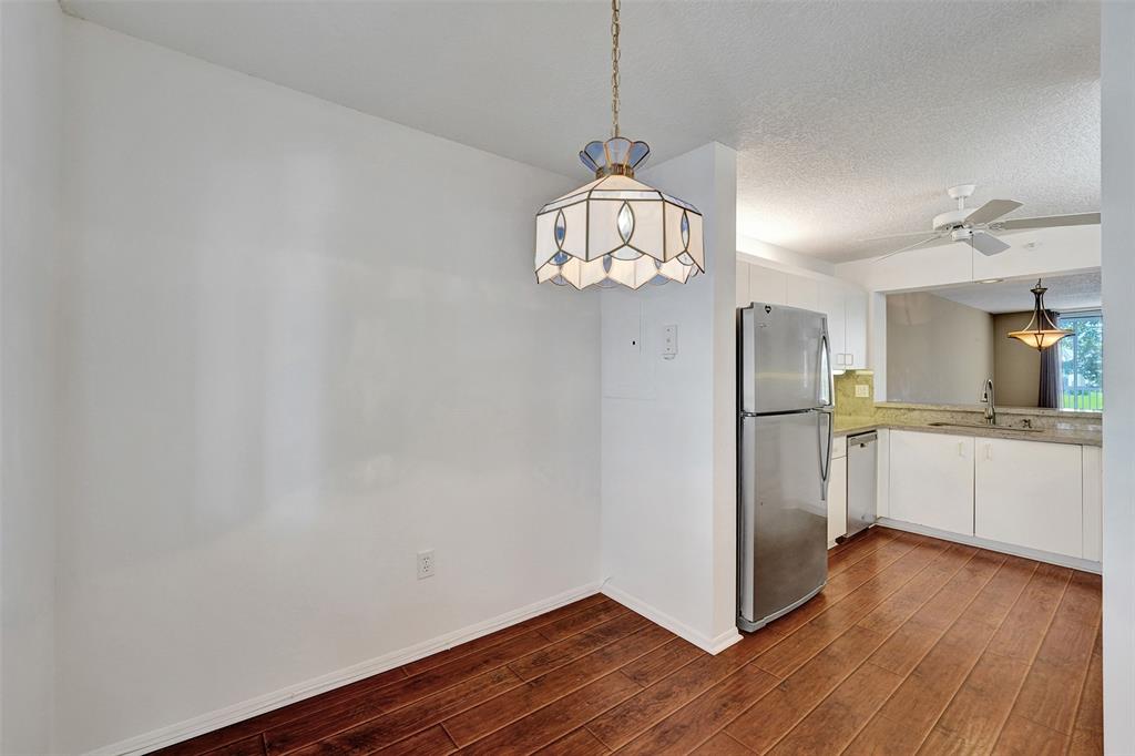 9563 Weldon Circle, Unit D212 Tamarac, FL 33321 - Photo 8 of 69 a view of a kitchen with stainless steel appliances granite countertop a refrigerator and a wooden floor