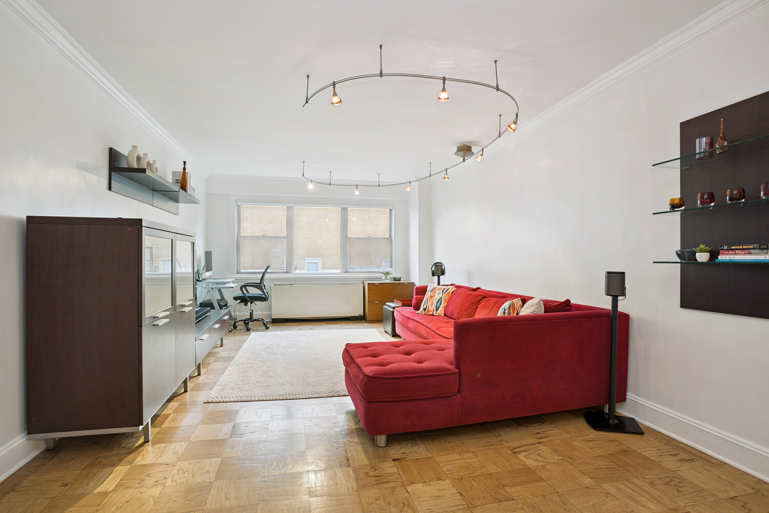 520 East 76th Street, Unit 8C Manhattan, NY 10021 - Photo 2 of 10 a living room with furniture wooden floor and a flat screen tv