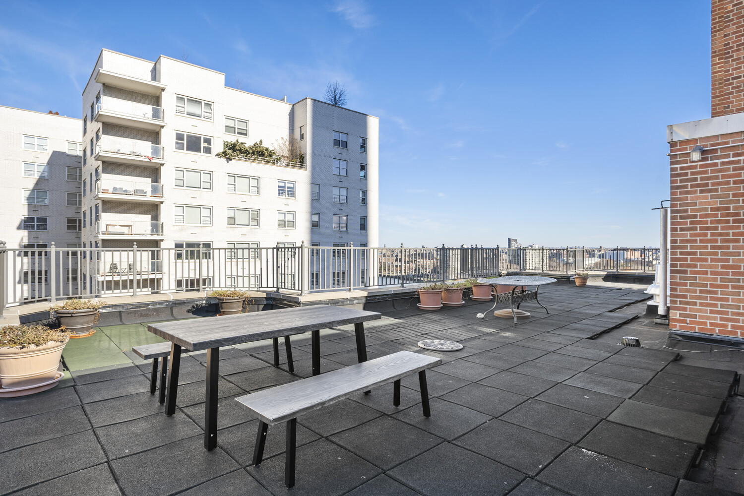 520 East 76th Street, Unit 8C Manhattan, NY 10021 - Photo 8 of 10 a roof deck with table and chairs