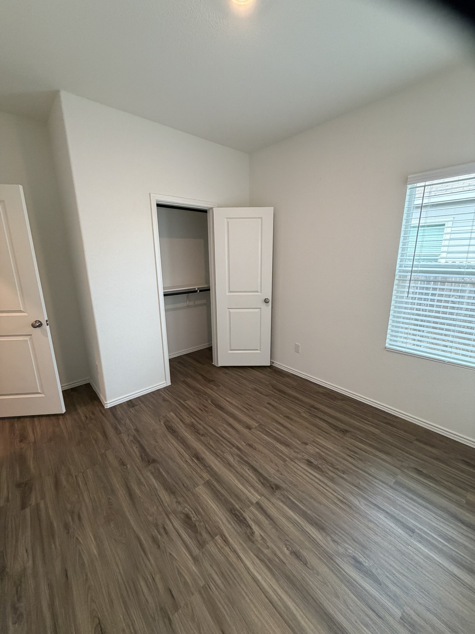 408 Buckners Street Georgetown, TX 78626 - Photo 7 of 15 an empty room with wooden floor and windows