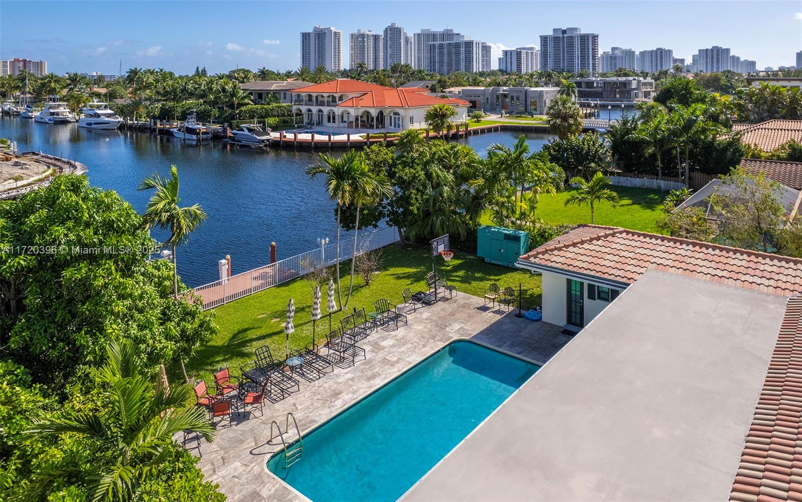 607 Layne Boulevard Hallandale Beach, FL 33009 - Photo 2 of 8 an aerial view of a house with a garden and lake view