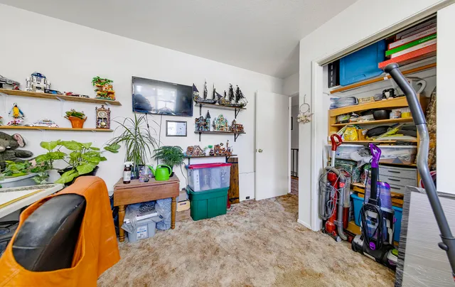 a view of a bedroom with furniture and toys