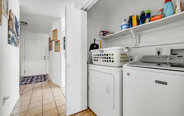 a hallway with a washer and dryer