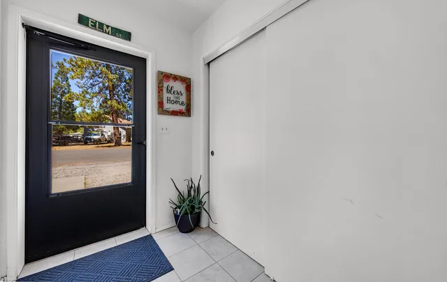 a view of a hallway with wooden floor and table