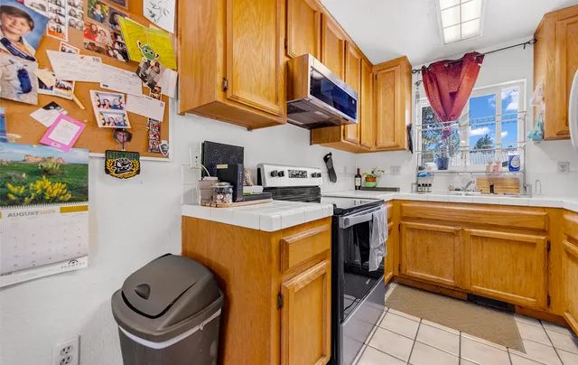 a kitchen with stainless steel appliances granite countertop a sink and a stove