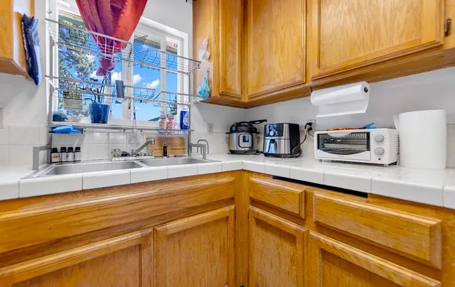 a kitchen with stainless steel appliances granite countertop a sink and cabinets