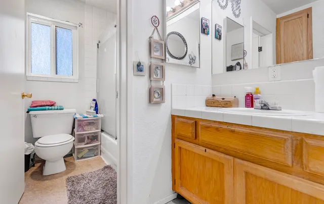 a bedroom with a bed and large window