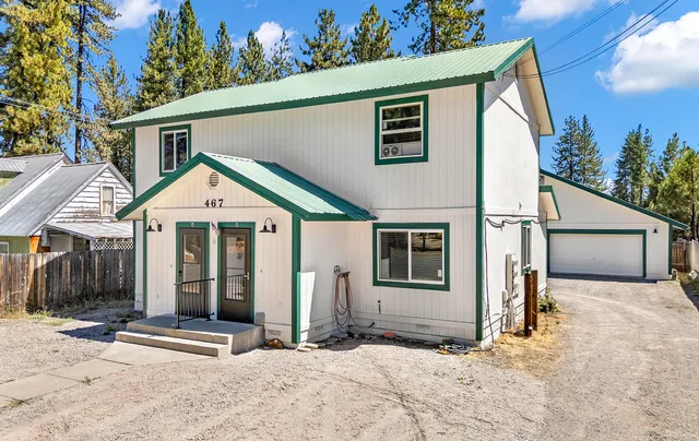 an aerial view of a houses with a yard