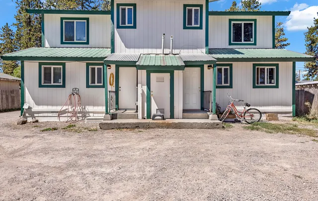 a front view of a house with patio furniture and a porch