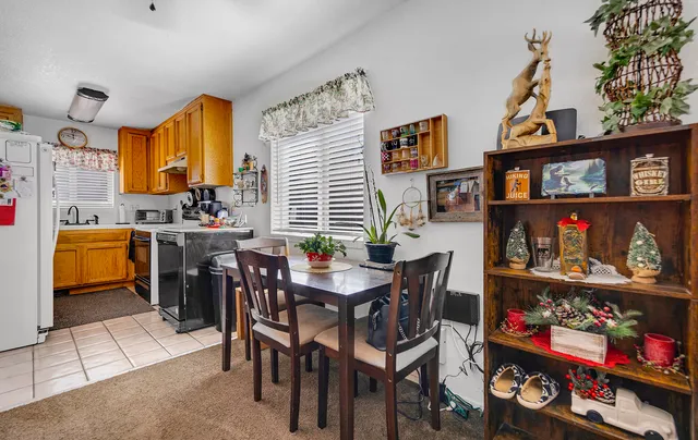 a dining room filled with lots of furniture and toys
