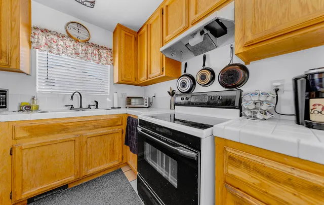 a kitchen with stainless steel appliances granite countertop a sink and cabinets
