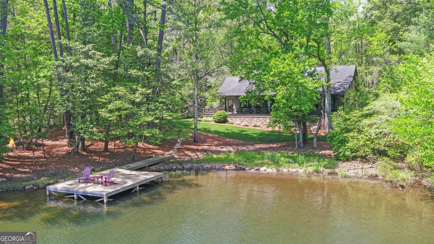 2857 Crow Creek Road Lakemont, GA 30552 - Photo 1 of 74 a view of a lake with a house in the background