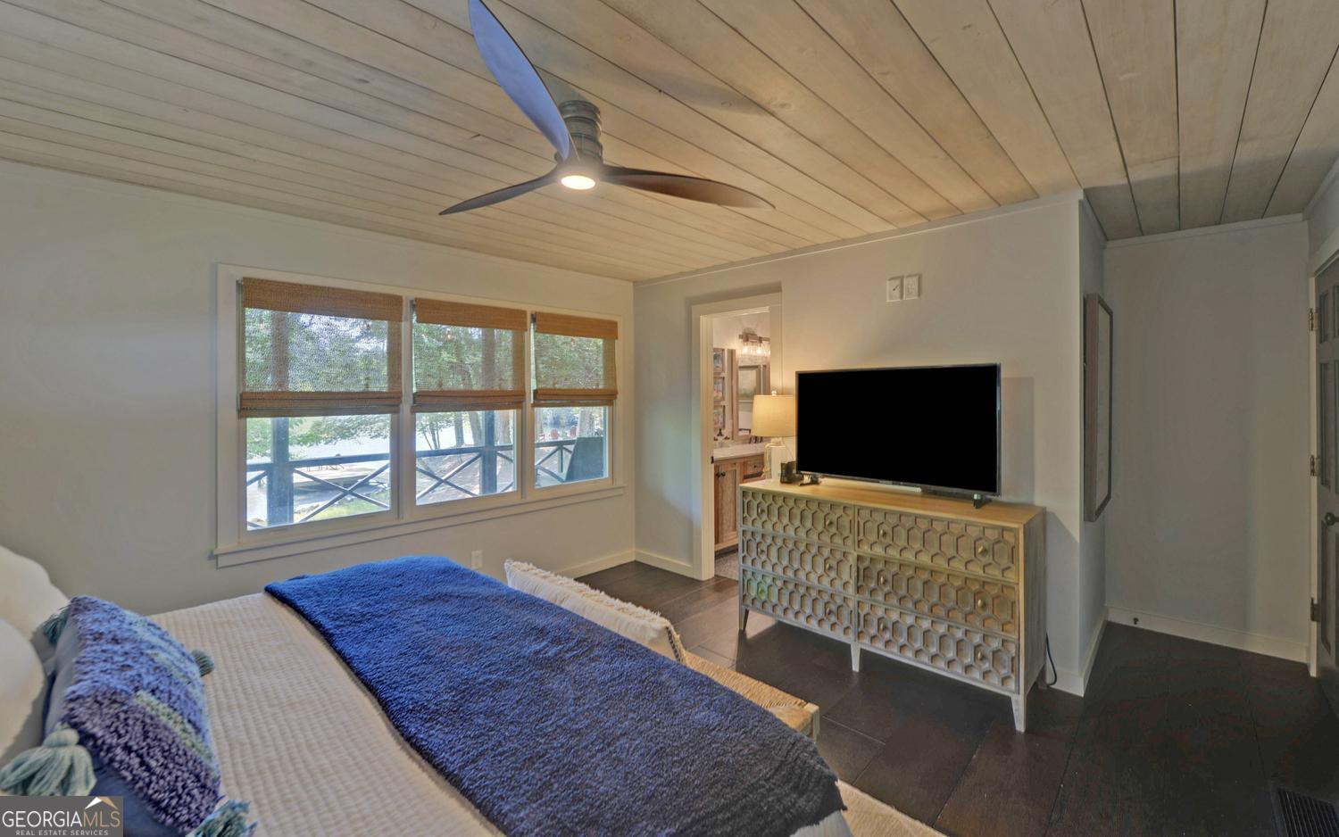 2857 Crow Creek Road Lakemont, GA 30552 - Photo 21 of 74 a bedroom with a bed and flat screen tv