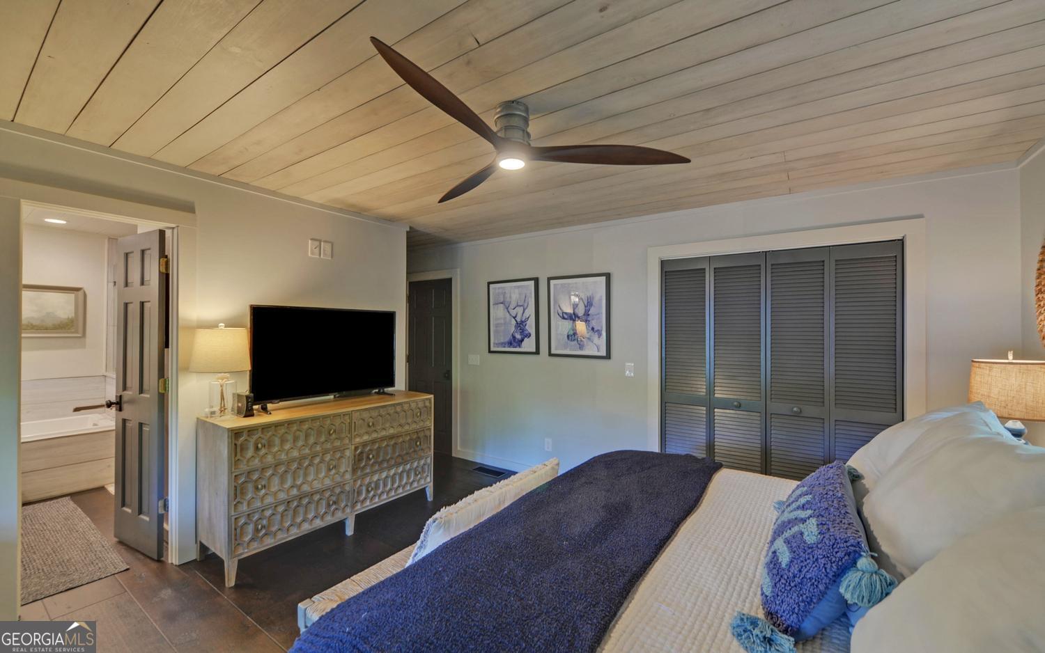 2857 Crow Creek Road Lakemont, GA 30552 - Photo 22 of 74 a bedroom with a bed and a flat screen tv