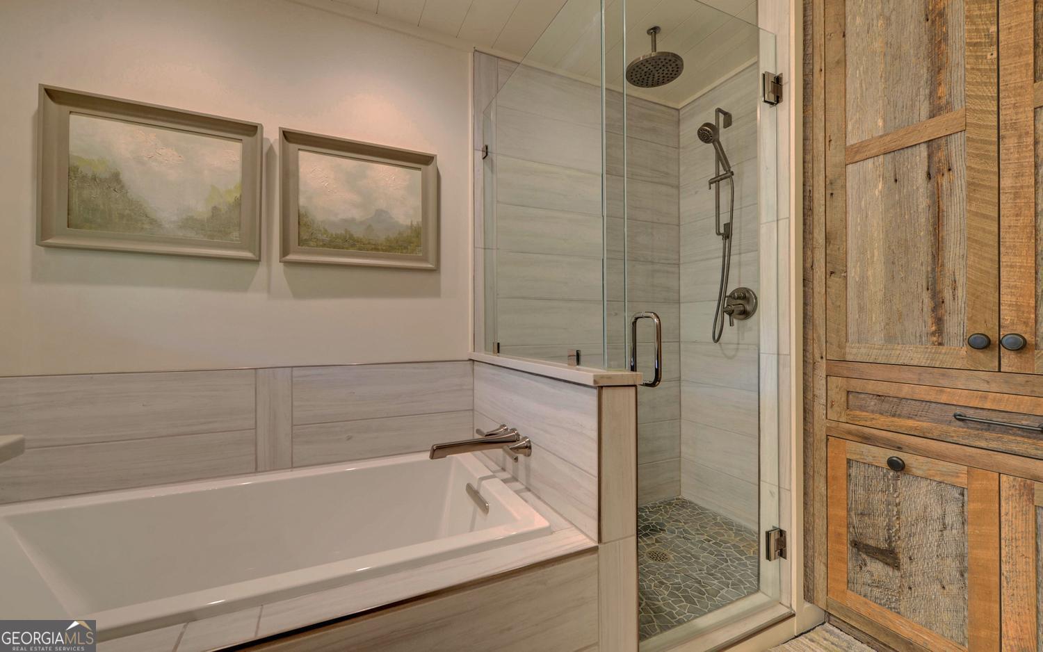 2857 Crow Creek Road Lakemont, GA 30552 - Photo 24 of 74 a bathroom with a bathtub and a shower