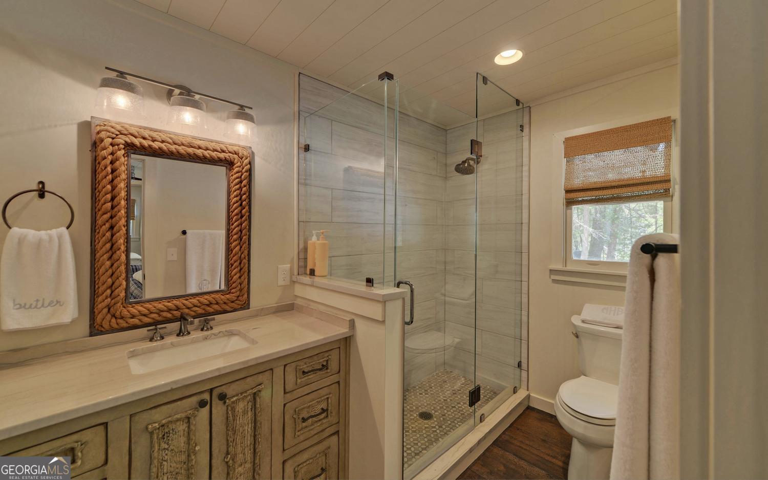 2857 Crow Creek Road Lakemont, GA 30552 - Photo 30 of 74 a bathroom with a granite countertop sink toilet and shower