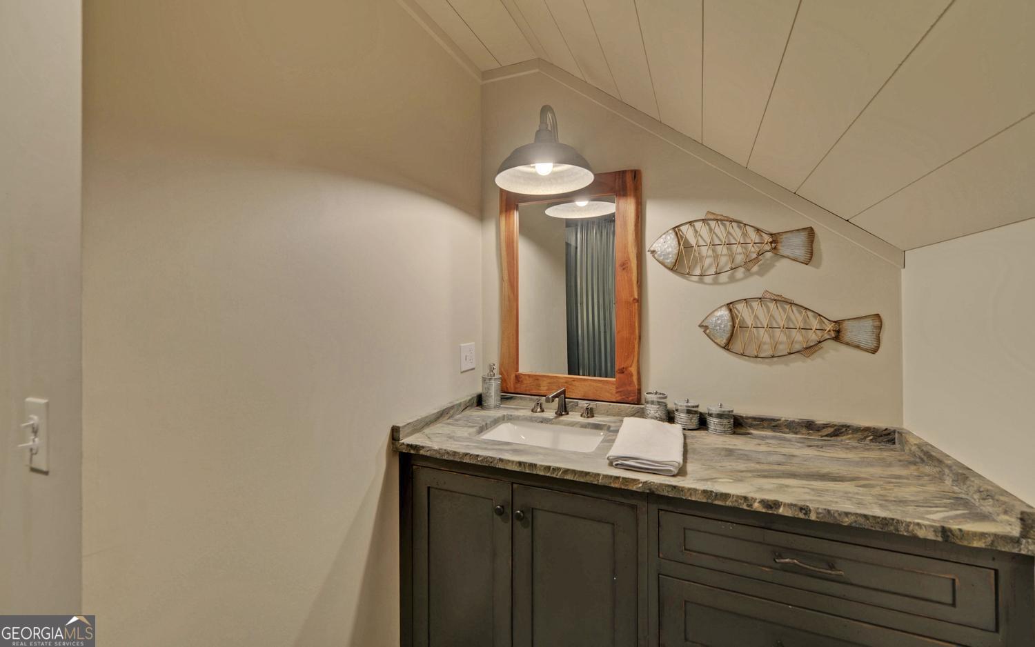 2857 Crow Creek Road Lakemont, GA 30552 - Photo 34 of 74 a bathroom with a granite countertop sink and a mirror