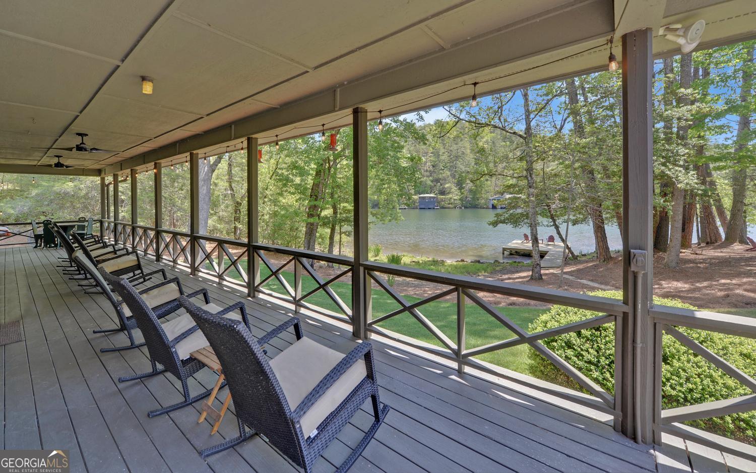 2857 Crow Creek Road Lakemont, GA 30552 - Photo 39 of 74 a view of a balcony with chairs and wooden floor
