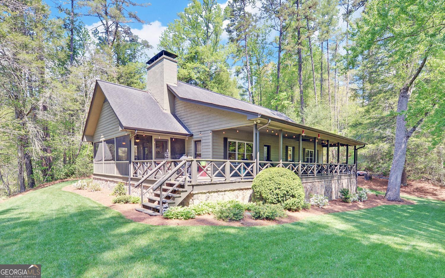 2857 Crow Creek Road Lakemont, GA 30552 - Photo 45 of 74 a view of a house with a yard and sitting area