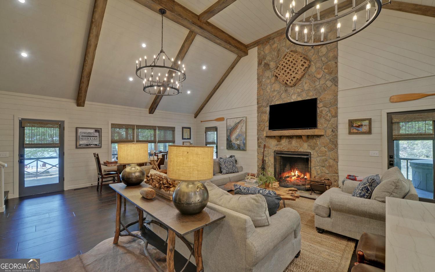 2857 Crow Creek Road Lakemont, GA 30552 - Photo 6 of 74 a living room with furniture a fireplace and a chandelier