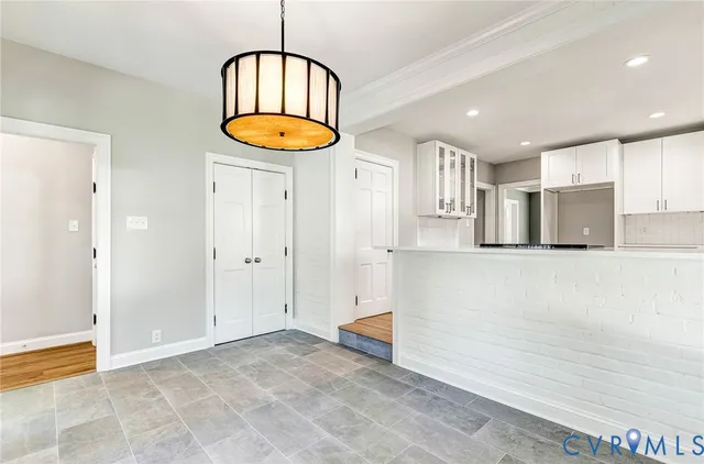 a view of empty room with wooden floor fireplace and windows