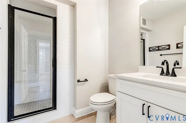 a view of empty room with wooden floor and fireplace